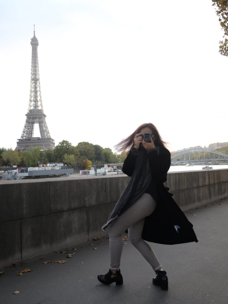 Hong Kong girl taking a photo in front of the Eiffel Tower in Paris