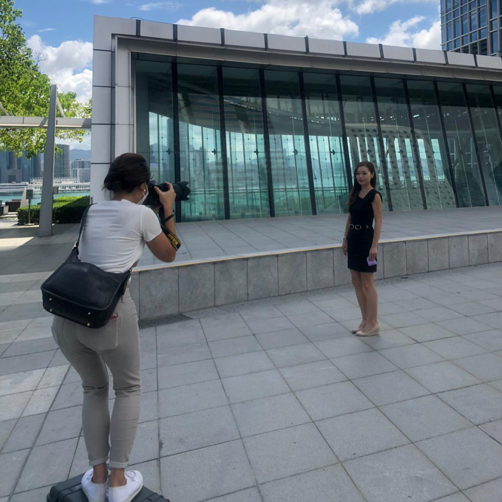 Hong Kong woman photographer taking a LinkedIn headshot for a business woman at the International Financial Center Mall
