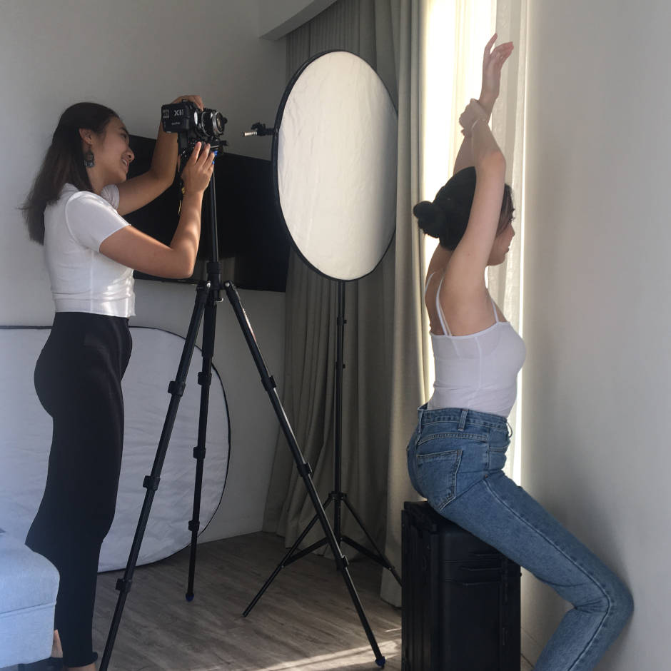 Hong Kong woman photographer takes a lifestyle photo of a female model